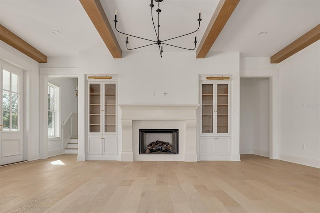 unfurnished living room featuring light hardwood / wood-style floors and beam ceiling