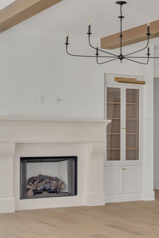 details featuring beamed ceiling and hardwood / wood-style flooring