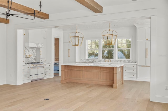 kitchen featuring backsplash, white cabinetry, light hardwood / wood-style floors, custom range hood, and beam ceiling