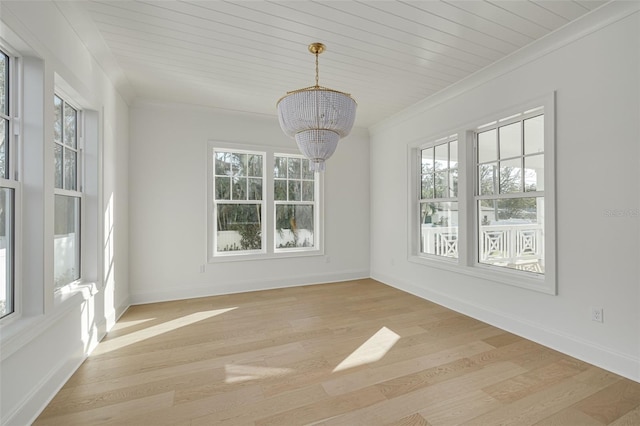 unfurnished dining area featuring a chandelier, plenty of natural light, and light wood-type flooring