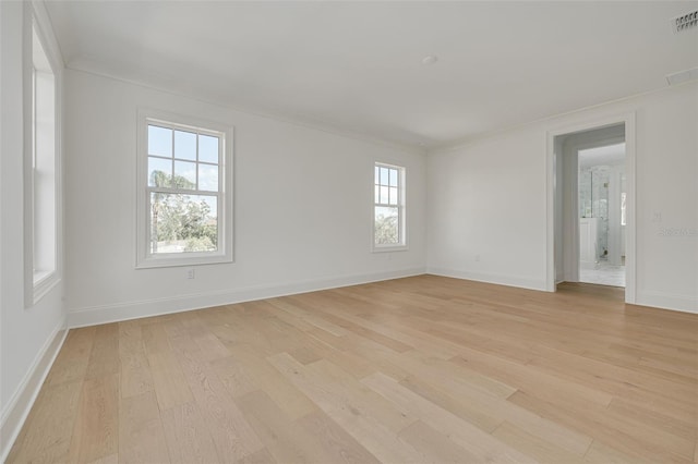 unfurnished room with crown molding and light wood-type flooring