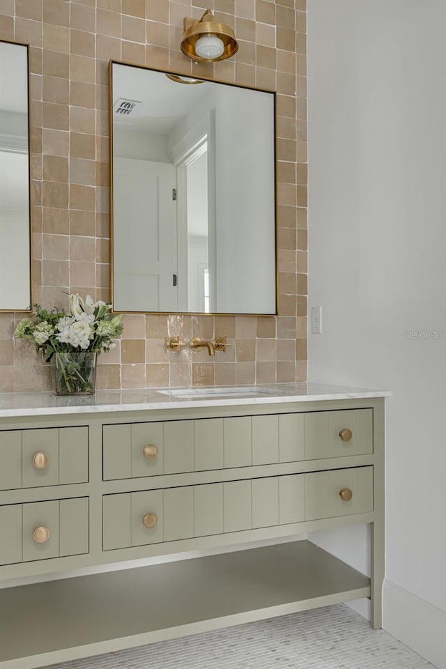 bathroom with vanity, tasteful backsplash, and tile patterned flooring