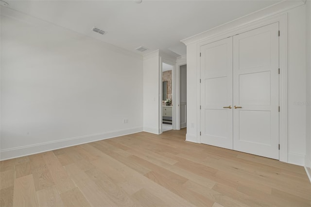 unfurnished bedroom with light hardwood / wood-style floors and a closet