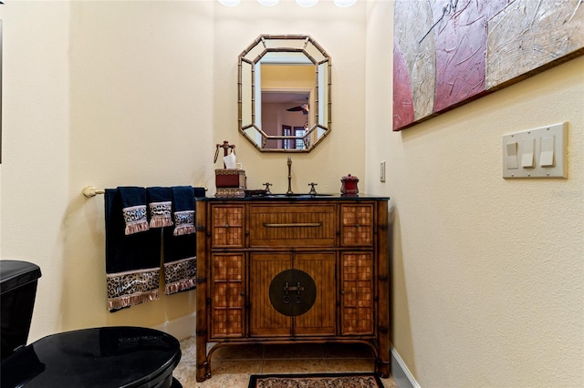 bathroom featuring vanity, toilet, and tile patterned flooring