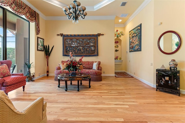 sitting room featuring light hardwood / wood-style floors, a notable chandelier, and ornamental molding