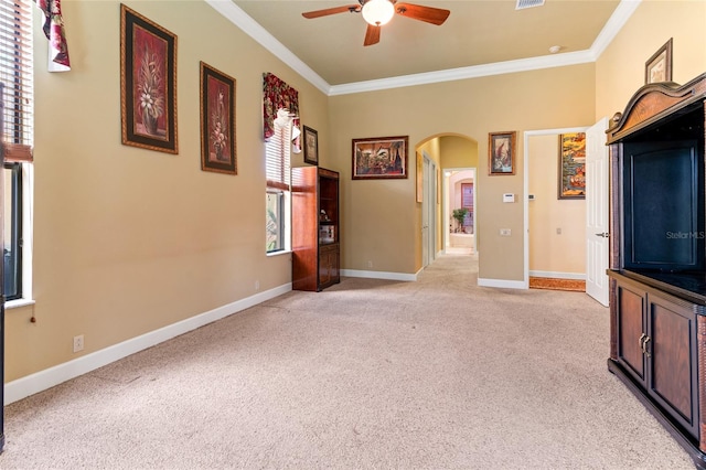 unfurnished living room with crown molding, a healthy amount of sunlight, and light carpet