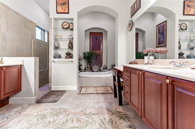 bathroom with vanity, tile patterned floors, separate shower and tub, and built in shelves