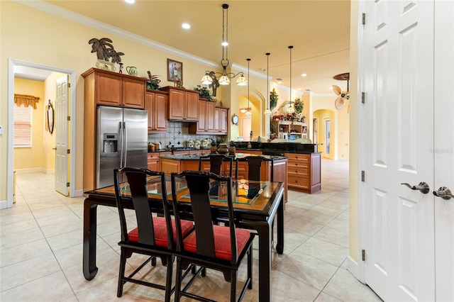 tiled dining area featuring crown molding