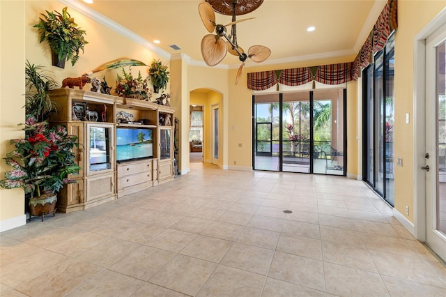 living room with ornamental molding, light tile patterned flooring, and ceiling fan