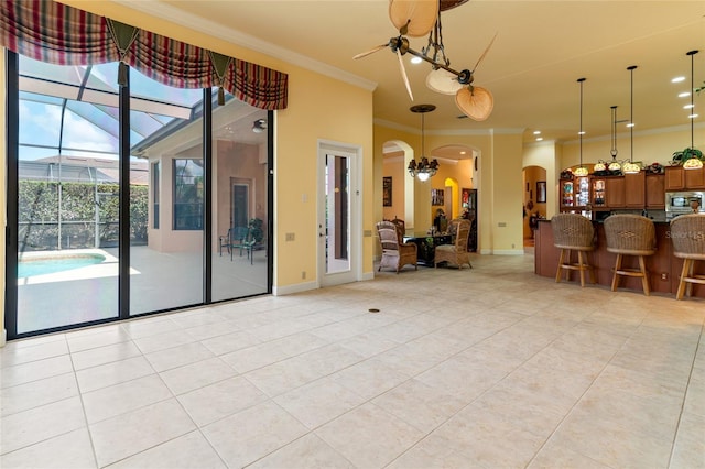 interior space featuring crown molding, a healthy amount of sunlight, and light tile patterned floors