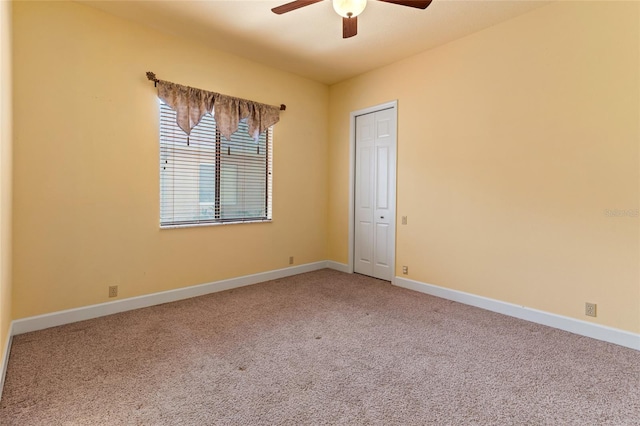 carpeted empty room with ceiling fan