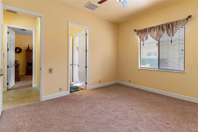 unfurnished bedroom with light carpet and ceiling fan