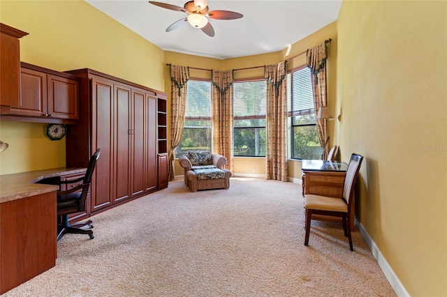 office area featuring ceiling fan and light colored carpet