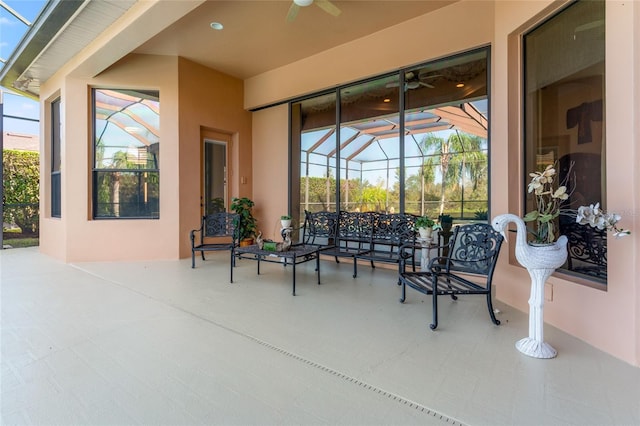 view of patio / terrace featuring glass enclosure and ceiling fan