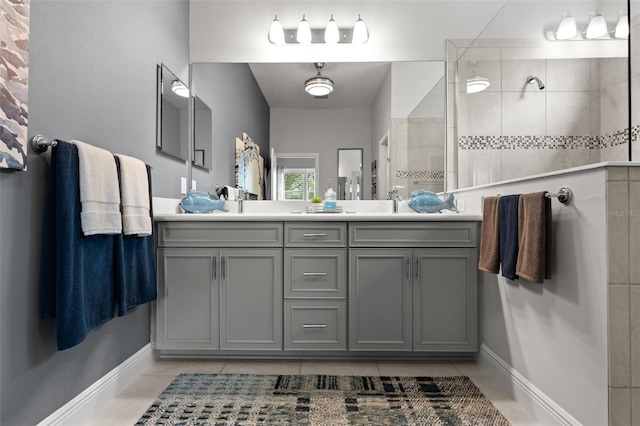 bathroom featuring vanity, tile patterned floors, and tiled shower