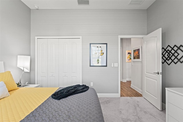 bedroom featuring light colored carpet and a closet