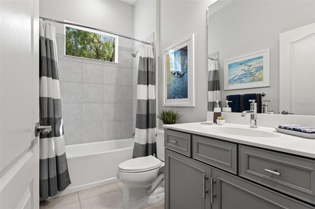 full bathroom with vanity, shower / bath combo with shower curtain, toilet, and tile patterned floors