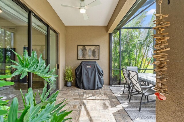 sunroom with ceiling fan and plenty of natural light