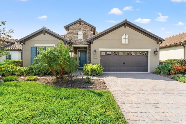 26810 Weiskopf Dr, Englewood, FL 34223 - traditional-style home featuring decorative driveway, an attached garage, and stucco siding