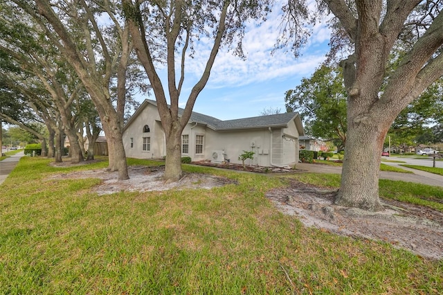 view of front of property with a front yard and a garage