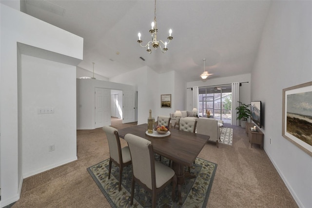 dining space with ceiling fan with notable chandelier, carpet floors, and vaulted ceiling