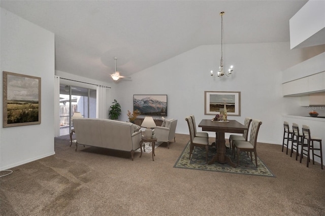 dining space with carpet flooring, ceiling fan with notable chandelier, and vaulted ceiling