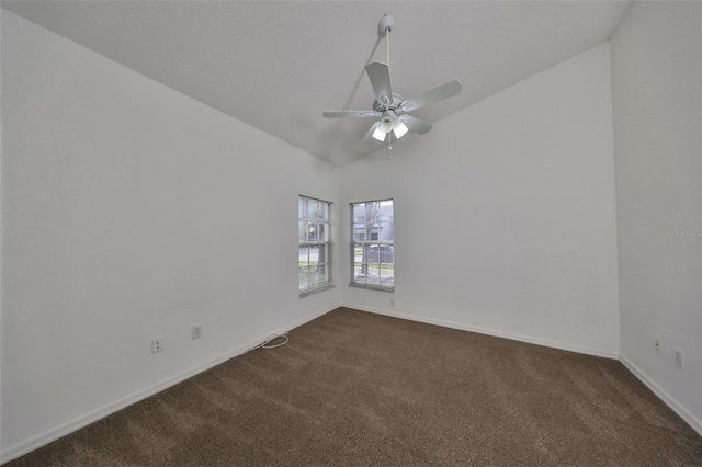 carpeted spare room featuring ceiling fan and lofted ceiling