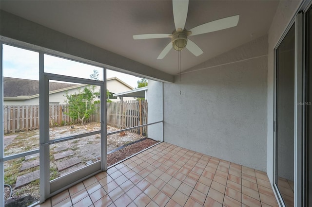 unfurnished sunroom with ceiling fan and lofted ceiling