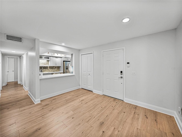 interior space featuring sink and light hardwood / wood-style floors