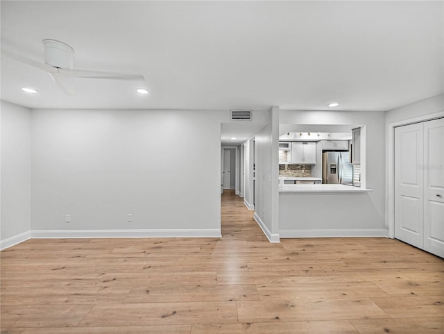 unfurnished living room with light wood-type flooring