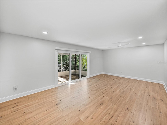 empty room with ceiling fan and light hardwood / wood-style floors