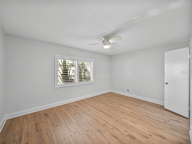 empty room featuring ceiling fan and light hardwood / wood-style floors