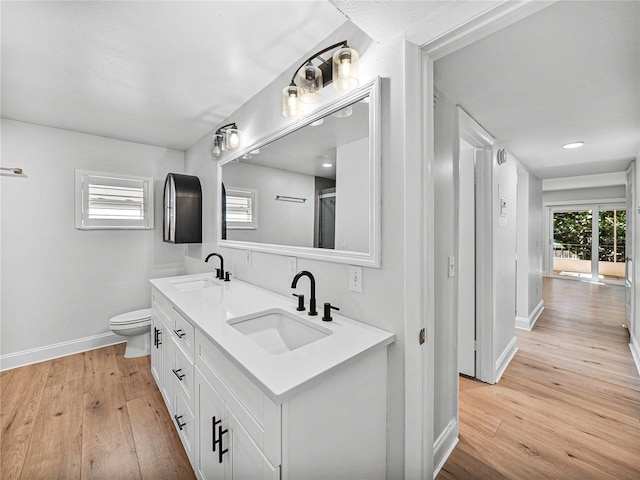 bathroom featuring hardwood / wood-style floors, vanity, and toilet