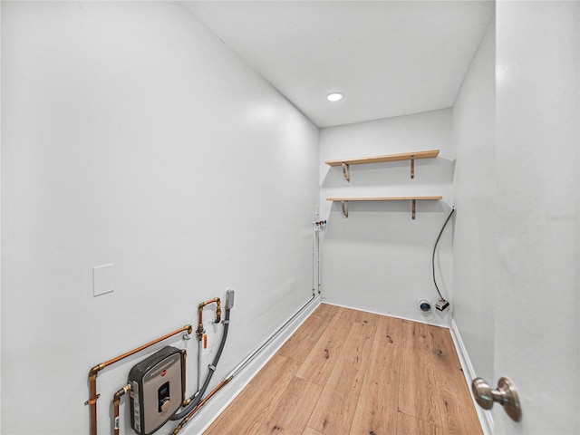 laundry area with hardwood / wood-style flooring