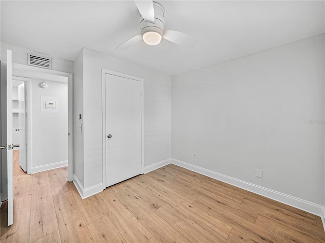 empty room featuring ceiling fan and light hardwood / wood-style flooring