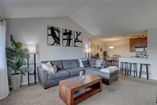 living room with lofted ceiling and light colored carpet