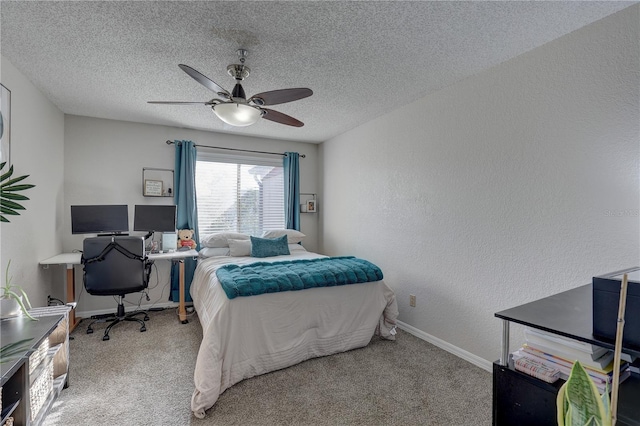 carpeted bedroom featuring a textured ceiling and ceiling fan