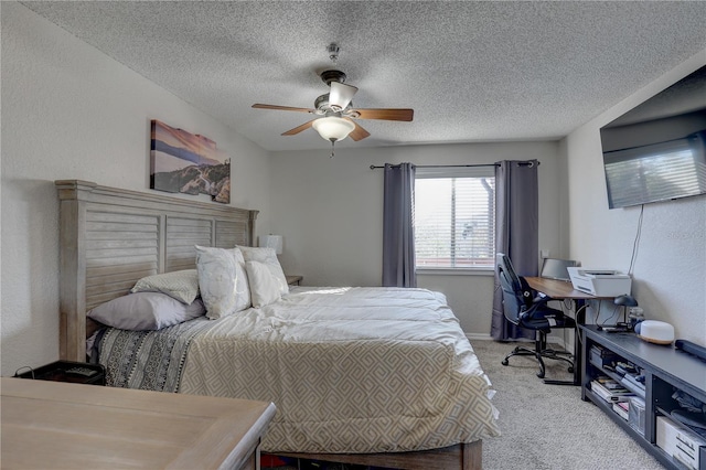 carpeted bedroom featuring ceiling fan and a textured ceiling