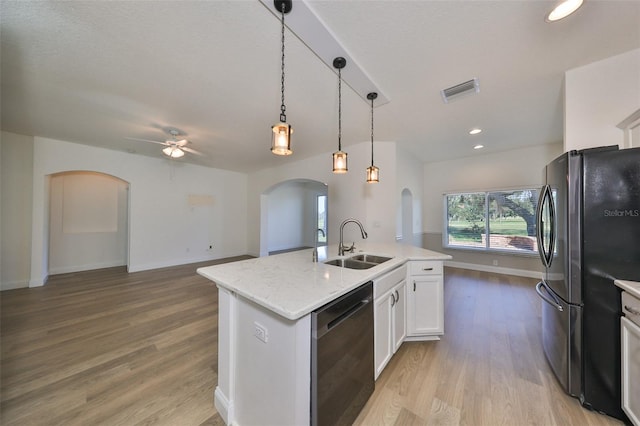 kitchen with a kitchen island with sink, light hardwood / wood-style flooring, sink, white cabinetry, and appliances with stainless steel finishes