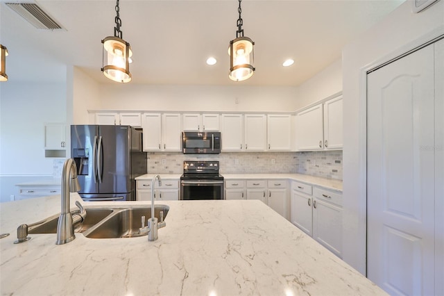 1148 Emerald Hill Way, Valrico, FL 33594 - kitchen with stainless steel appliances, a sink, backsplash, white cabinets, and pendant lighting