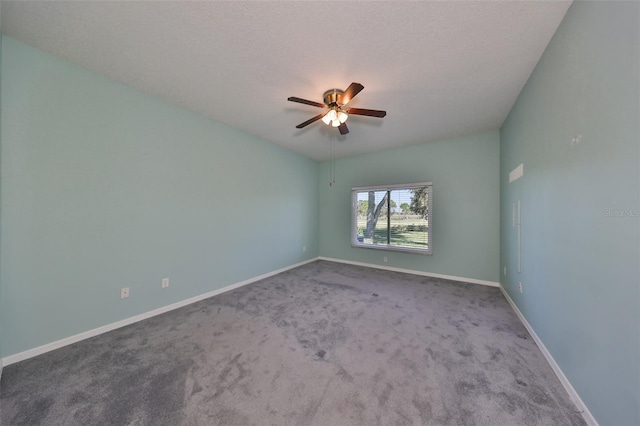 spare room featuring a textured ceiling, carpet flooring, and ceiling fan