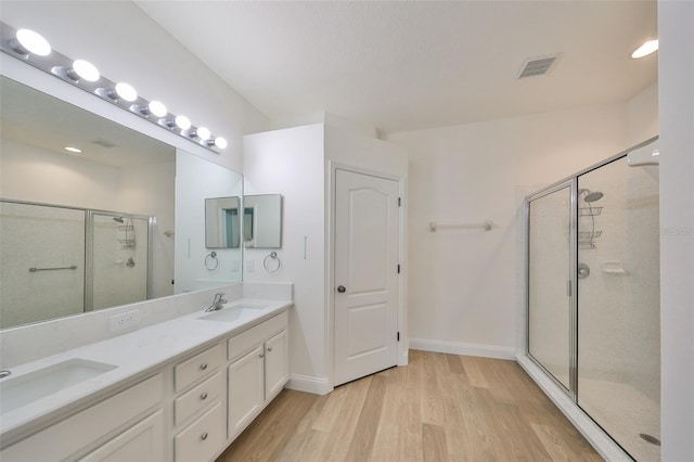 bathroom featuring vanity, walk in shower, and hardwood / wood-style floors