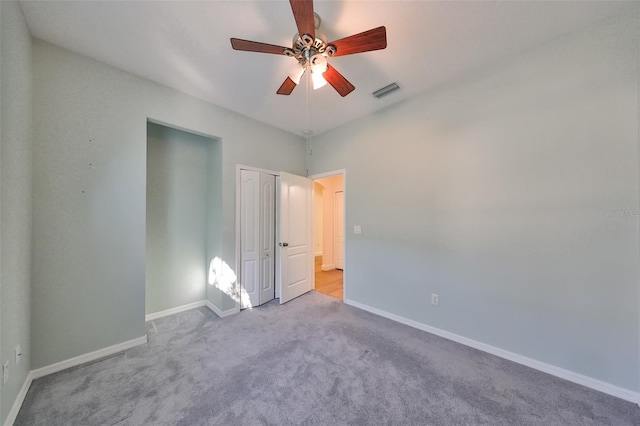 empty room featuring light colored carpet and ceiling fan