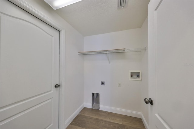 laundry area with hookup for an electric dryer, a textured ceiling, washer hookup, and wood-type flooring