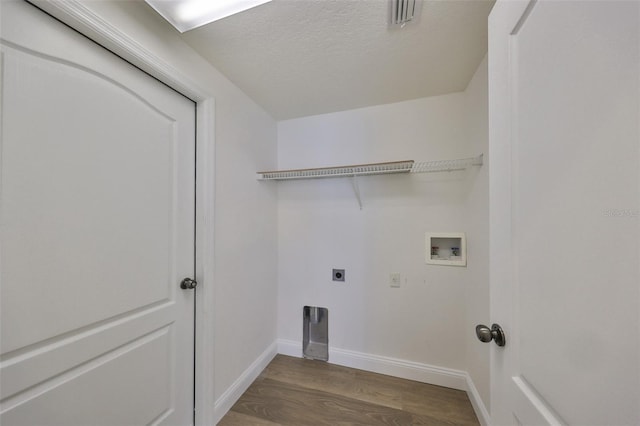 1148 Emerald Hill Way, Valrico, FL 33594 - washroom with electric dryer hookup, hookup for a washing machine, wood finished floors, baseboards, and a textured ceiling