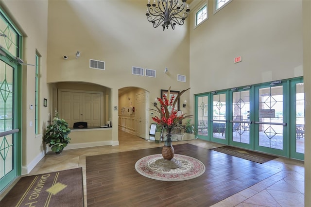 1148 Emerald Hill Way, Valrico, FL 33594 - entrance foyer with a towering ceiling, a chandelier, arched walkways, baseboards, and wood finished floors