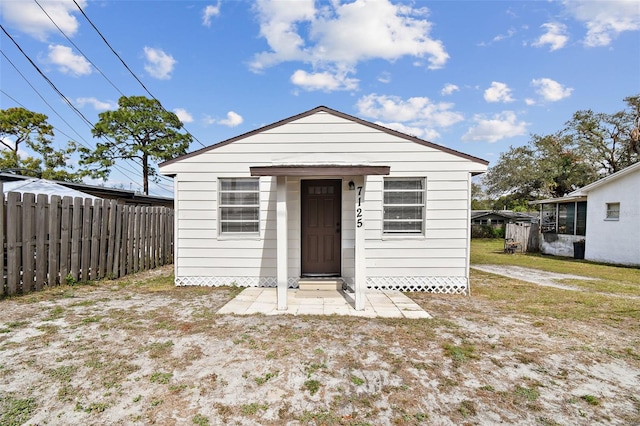 bungalow-style house featuring a front yard