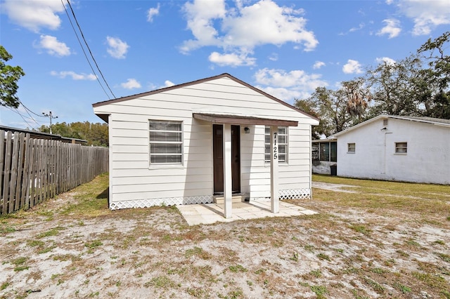 rear view of property with an outbuilding