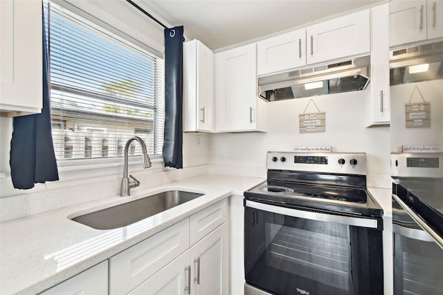 kitchen with light stone countertops, sink, white cabinets, and stainless steel electric stove