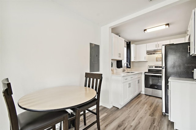 kitchen featuring refrigerator, white cabinetry, light hardwood / wood-style flooring, and stainless steel electric range oven